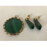 A yellow metal mounted malachite pendant together with matching earrings.
