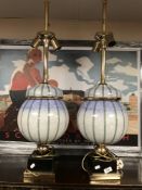 A pair of ornate ceramic and brass bulbous table lamps,