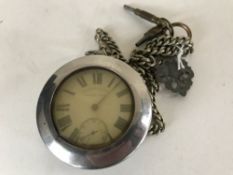 A silver pocket watch English Lever, suspended upon a chain with two keys.