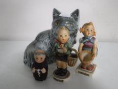 A Goebel money box modelled as a cat together with two Goebel figures - Boy and girl with basket