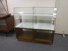 A mid 20th century glass shop display cabinet