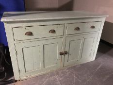 An antique painted pine kitchen dresser base