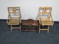 An early 20th century counter top cigar cabinet and a pair of folding child's chairs