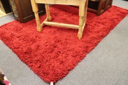 An Indian hand made deep pile shaggy carpet in red,