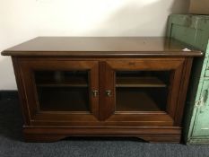 An Elegance Furniture entertainment stand in cherry wood finish