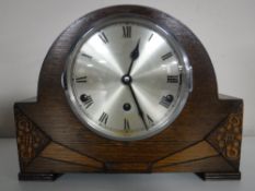 An oak Westminster chiming mantle clock with pendulum and key