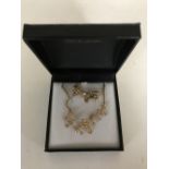 A 9ct gold seed pearl mounted bow brooch together with the matching necklace and pendant.
