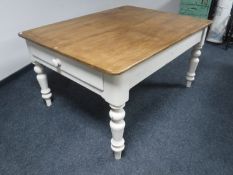 A pine farmhouse kitchen table fitted a drawer on painted base