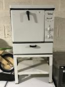 A mid 20th century Belling enamelled oven on stand