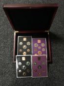A mahogany coin case containing four slides of Royal Mint British coins - 1970,1971, 1978 & 1980.