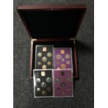 A mahogany coin case containing four slides of Royal Mint British coins - 1970,1971, 1978 & 1980.