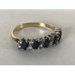 An 18ct gold sapphire and diamond half eternity ring, size N.