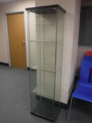 A contemporary square glass display cabinet
