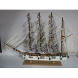 A wooden model of a four masted baroque sailing ship on stand
