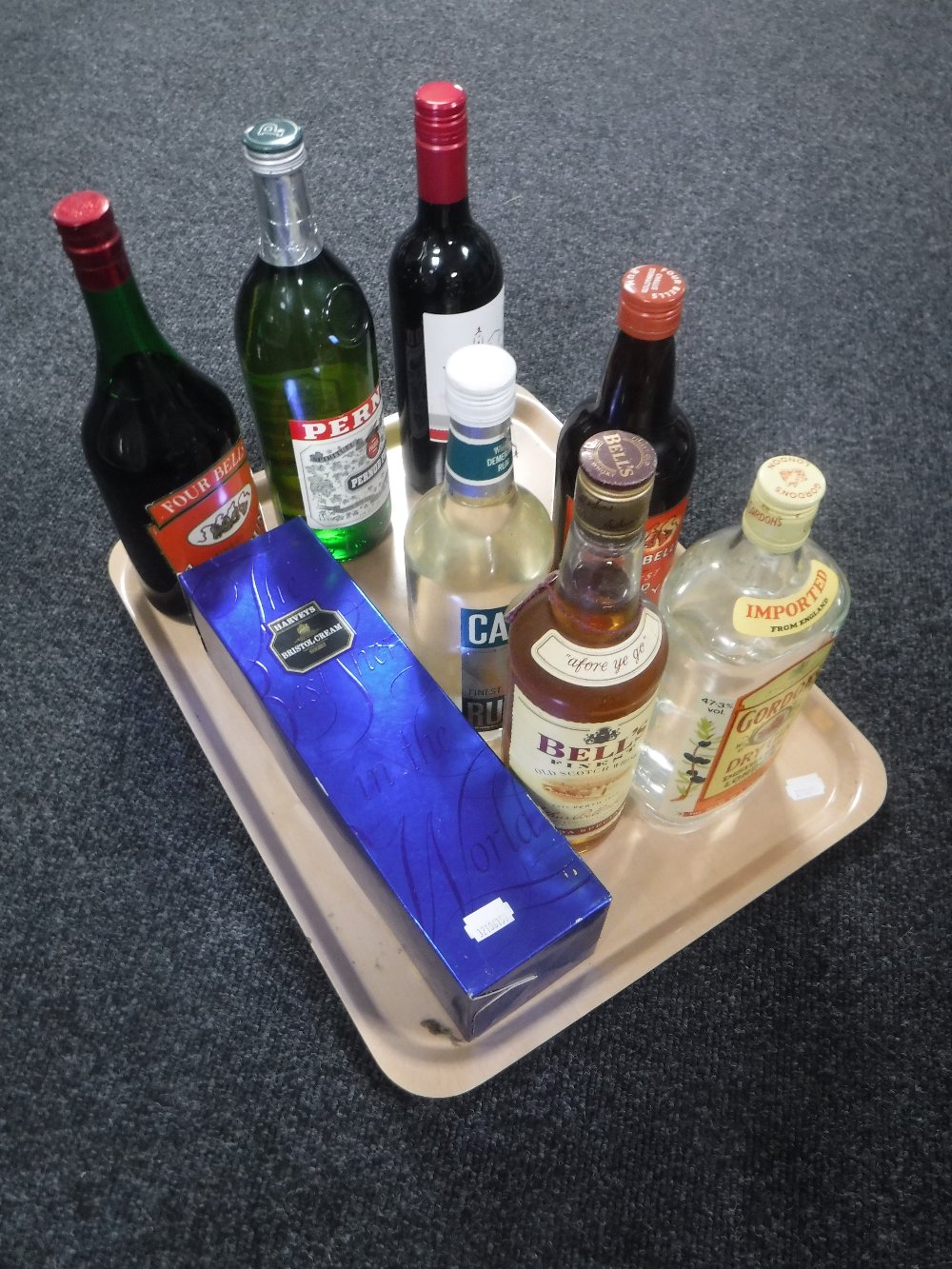 A tray of eight bottles of wines and spirits including Gordons gin, Bells whisky,