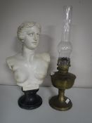 A brass Aladdin oil lamp with glass chimney together with a resin bust of Venus on stand