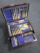 An antique mahogany cutlery canteen fitted with two drawers containing stainless steel and plated