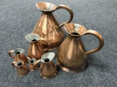 A set of seven antique copper graduated measuring jugs CONDITION REPORT: Largest of