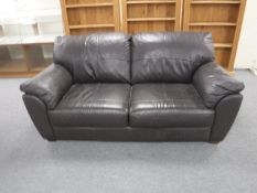 A brown leather two seater settee