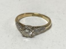 An 18ct gold solitaire diamond ring, approximately 0.5ct, size J, set with diamond shoulders.