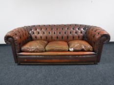 A brown button leather Chesterfield three seater settee