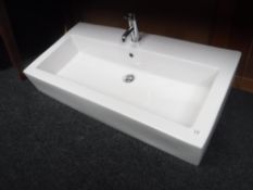 A large double ceramic hand basin with taps