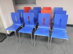 A set of twelve contemporary stacking chairs (nine blue three red)