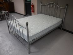 A 4'6 metal bed frame with Silentnight mattress
