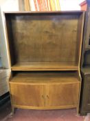 A set of walnut open bookshelves fitted cupboards beneath