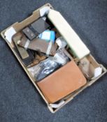 A box containing gents travel set, vintage boxed darts, vintage leather tape measure, tie presses,