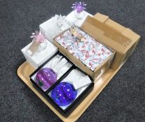 A tray containing three boxed crystal pineapple paperweights together with two boxed coloured glass