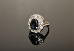 An 18ct gold sapphire and diamond cluster ring,