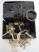 A vintage metal cash box with key containing costume jewellery
