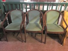 A set of three stained beech armchairs upholstered in a green dralon