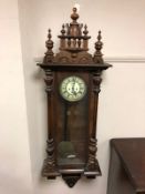 A late Victorian mahogany wall clock with pendulum