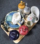 A tray containing a glass figure of a seal, pottery Scotch whisky decanters, beer steins,