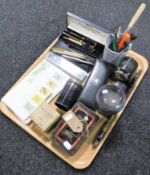 A tray containing a Dahle Bakelite pencil sharpener, vintage metal money box,