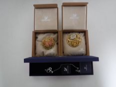 A boxed Swarovski bracelet and a two boxed Swarovski brooches