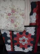 A vintage floral quilt and a patchwork quilt