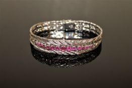 A fine quality ruby and diamond bracelet in 18ct white gold, 52g.
