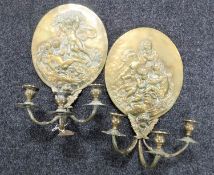 A pair of brass embossed candle wall sconces