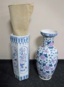 An oriental style porcelain stick stand and vase together with a fringed rug