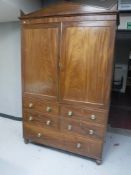 A Regency mahogany linen press with arched cornice,