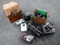 A box of cameras including Olympus OM 10, two Macro tamron lenses,