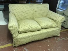 An early twentieth century two seater settee with loose covers
