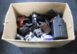 A box of assorted cameras and accessories