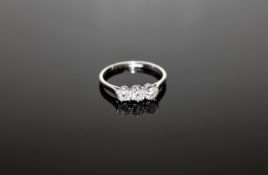 A platinum diamond three stone ring, approximately 0.75ct, size N.