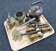 A tray containing brass and copper kettle, three cannon ornaments,