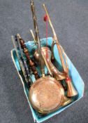 A box containing assorted brass ware including bed warming pans, hunting horn,