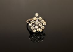 An 18ct gold diamond cluster ring, with fifteen brilliant-cut stones within raised claw settings,